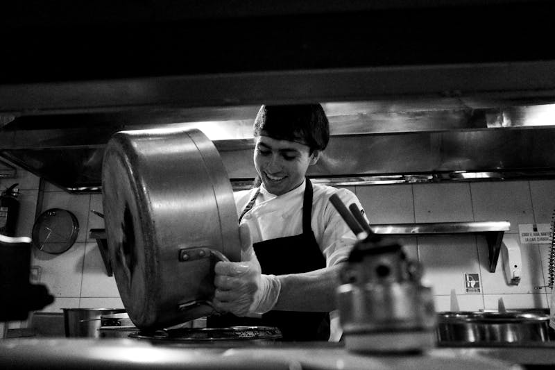 Dedicated kitchen team at Jet's pizza preparing fresh food